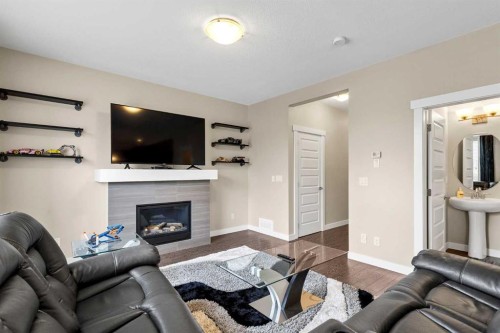 1701-1086 Williamstown Boulevard Nw, Airdrie, AB - Indoor Photo Showing Living Room With Fireplace