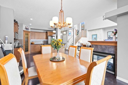 22 Westfall Drive, Okotoks, AB - Indoor Photo Showing Dining Room With Fireplace