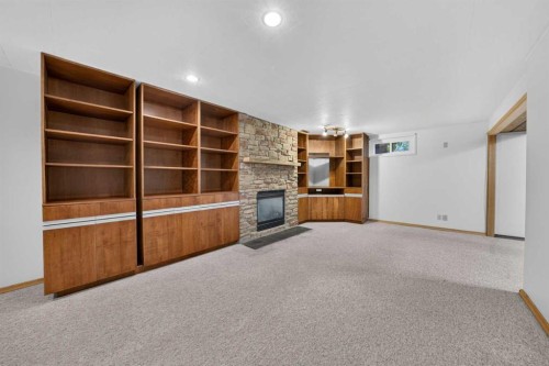 135 Huntcroft Way Ne, Calgary, AB - Indoor Photo Showing Other Room With Fireplace