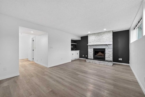 1091 Berkley Drive Nw, Calgary, AB - Indoor Photo Showing Living Room With Fireplace