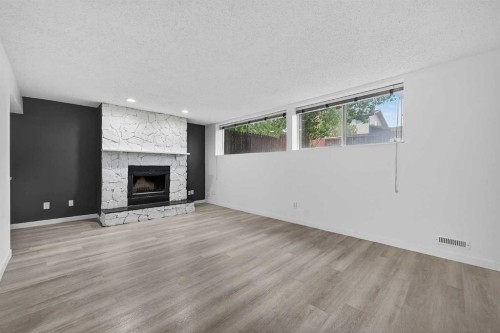 1091 Berkley Drive Nw, Calgary, AB - Indoor Photo Showing Living Room With Fireplace