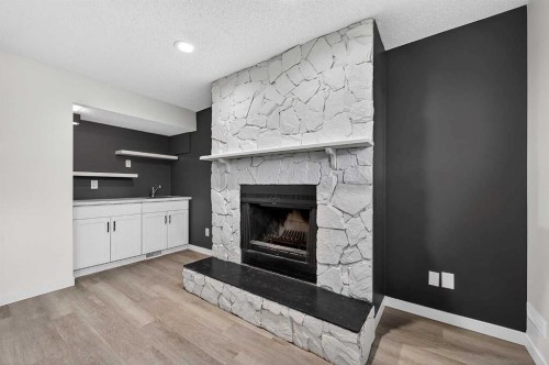 1091 Berkley Drive Nw, Calgary, AB - Indoor Photo Showing Living Room With Fireplace