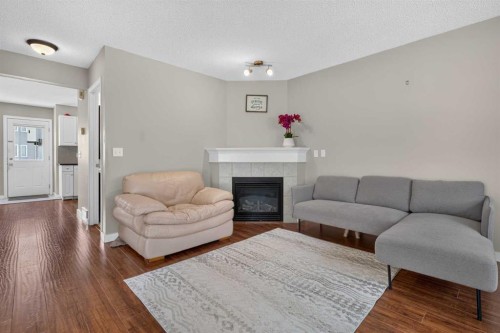 118 Royal Birch Villas Nw, Calgary, AB - Indoor Photo Showing Living Room With Fireplace