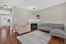 118 Royal Birch Villas Nw, Calgary, AB  - Indoor Photo Showing Living Room With Fireplace 