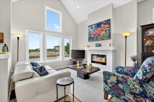 1066 Creekside Boulevard Sw, Calgary, AB - Indoor Photo Showing Living Room With Fireplace