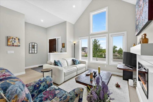 1066 Creekside Boulevard Sw, Calgary, AB - Indoor Photo Showing Living Room With Fireplace