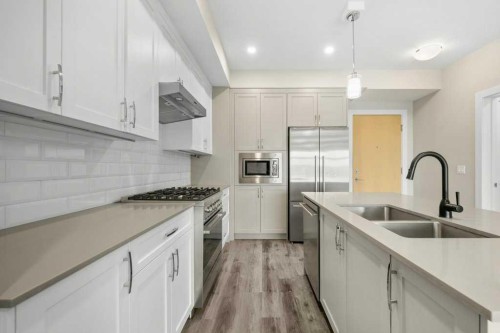 306-1702 17 Avenue Sw, Calgary, AB - Indoor Photo Showing Kitchen With Stainless Steel Kitchen With Double Sink With Upgraded Kitchen