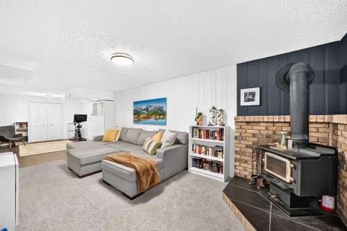 8632 Atlas Drive Se, Calgary, AB - Indoor Photo Showing Other Room With Fireplace