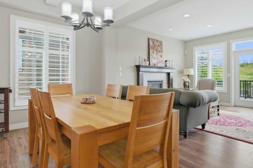 27 Jumping Pound Terrace, Cochrane, AB - Indoor Photo Showing Dining Room With Fireplace