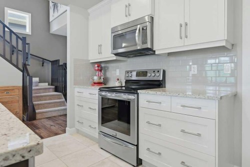 27 Jumping Pound Terrace, Cochrane, AB - Indoor Photo Showing Kitchen With Upgraded Kitchen