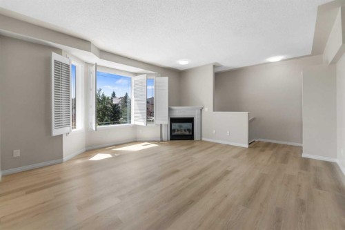 116 Country Hills Gardens Nw, Calgary, AB - Indoor Photo Showing Living Room With Fireplace
