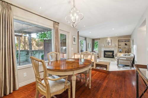 48 Patterson Mews Sw, Calgary, AB - Indoor Photo Showing Dining Room With Fireplace