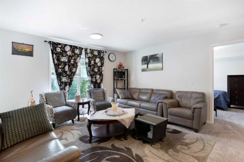 210-2000 Applevillage Court Se, Calgary, AB - Indoor Photo Showing Living Room
