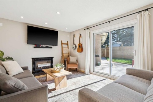 16 Brenner Place Nw, Calgary, AB - Indoor Photo Showing Living Room With Fireplace