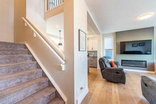 153 Waterford Boulevard, Chestermere, AB - Indoor Photo Showing Other Room With Fireplace