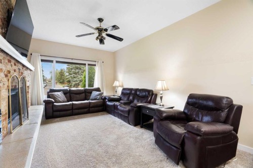 48 Deermont Way Se, Calgary, AB - Indoor Photo Showing Living Room With Fireplace