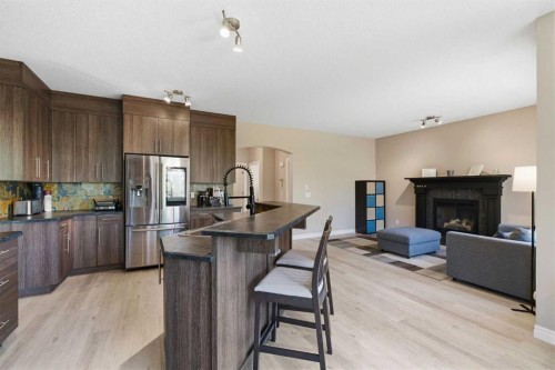 331 Parkmere Green, Chestermere, AB - Indoor Photo Showing Kitchen With Fireplace With Stainless Steel Kitchen