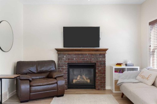 590 Coopers Drive Sw, Airdrie, AB - Indoor Photo Showing Living Room With Fireplace