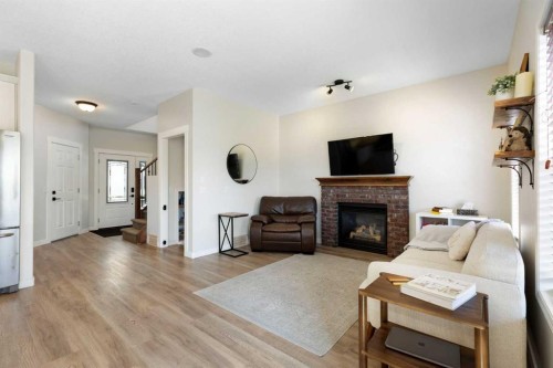590 Coopers Drive Sw, Airdrie, AB - Indoor Photo Showing Living Room With Fireplace