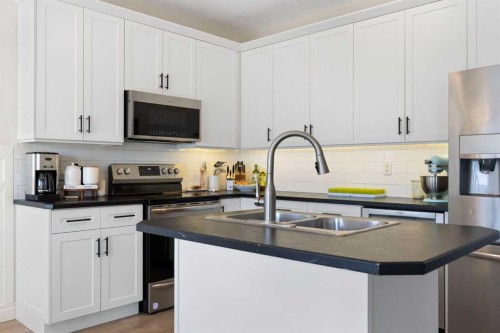 590 Coopers Drive Sw, Airdrie, AB - Indoor Photo Showing Kitchen With Stainless Steel Kitchen With Double Sink With Upgraded Kitchen