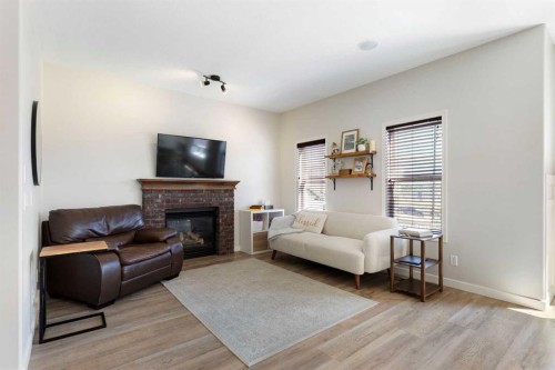 590 Coopers Drive Sw, Airdrie, AB - Indoor Photo Showing Living Room With Fireplace