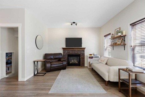 590 Coopers Drive Sw, Airdrie, AB - Indoor Photo Showing Living Room With Fireplace
