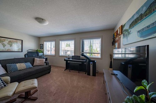 144 Everhollow Street Sw, Calgary, AB - Indoor Photo Showing Living Room