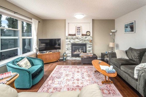 125 Silverado Range Cove Sw, Calgary, AB - Indoor Photo Showing Living Room With Fireplace