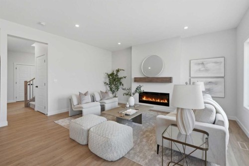27 Verdure Gate Sw, Calgary, AB - Indoor Photo Showing Living Room With Fireplace