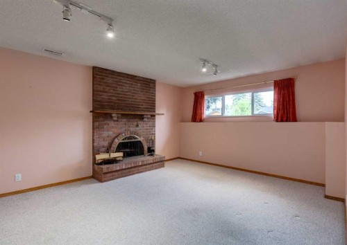 9527 Oakland Way Sw, Calgary, AB - Indoor With Fireplace