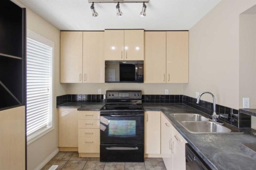 3032 New Brighton Gardens Se, Calgary, AB - Indoor Photo Showing Kitchen With Double Sink