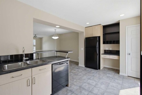 3032 New Brighton Gardens Se, Calgary, AB - Indoor Photo Showing Kitchen With Double Sink