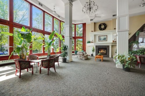 227-1920 14 Avenue Ne, Calgary, AB - Indoor Photo Showing Other Room With Fireplace