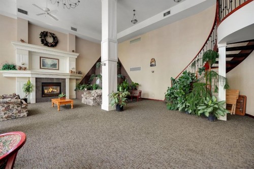 227-1920 14 Avenue Ne, Calgary, AB - Indoor Photo Showing Other Room With Fireplace