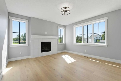 1209 Coopers Drive Sw, Airdrie, AB - Indoor Photo Showing Living Room With Fireplace