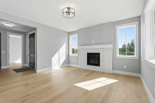 1209 Coopers Drive Sw, Airdrie, AB - Indoor Photo Showing Living Room With Fireplace