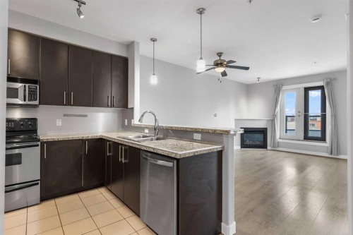 405-880 Centre Avenue Ne, Calgary, AB - Indoor Photo Showing Kitchen With Fireplace With Double Sink