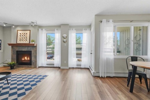 122-860 Midridge Drive Se, Calgary, AB - Indoor Photo Showing Other Room With Fireplace
