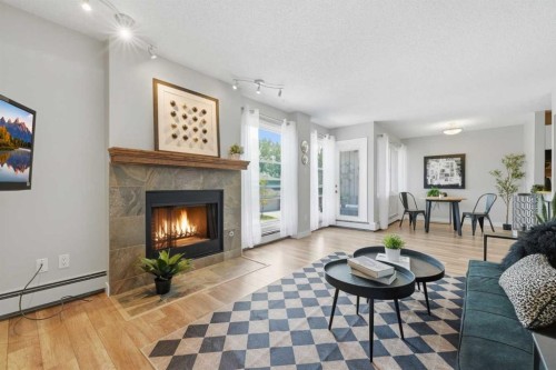 122-860 Midridge Drive Se, Calgary, AB - Indoor Photo Showing Living Room With Fireplace