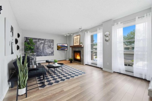 122-860 Midridge Drive Se, Calgary, AB - Indoor Photo Showing Living Room With Fireplace
