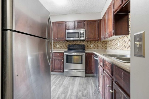 406-145 Point Drive Nw, Calgary, AB - Indoor Photo Showing Kitchen With Double Sink