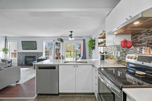31 Mt Aberdeen Grove Se, Calgary, AB - Indoor Photo Showing Kitchen With Fireplace