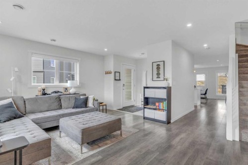 302-260 Rowley Way Nw, Calgary, AB - Indoor Photo Showing Living Room With Fireplace