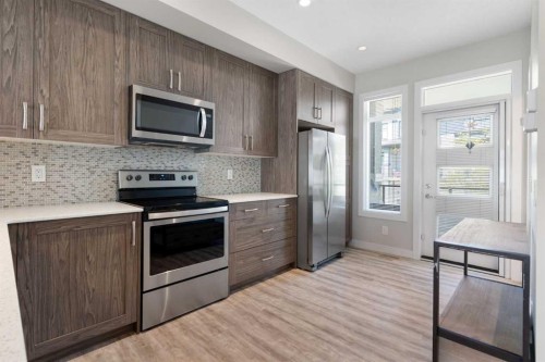 28-138 Seton Passage Se, Calgary, AB - Indoor Photo Showing Kitchen With Stainless Steel Kitchen With Upgraded Kitchen