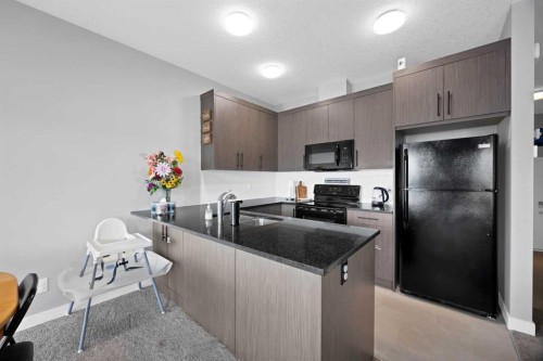 107 Jumping Pound Common, Cochrane, AB - Indoor Photo Showing Kitchen With Double Sink