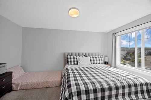 107 Jumping Pound Common, Cochrane, AB - Indoor Photo Showing Bedroom