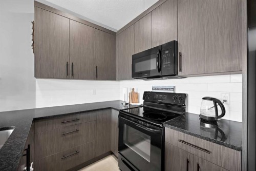 107 Jumping Pound Common, Cochrane, AB - Indoor Photo Showing Kitchen