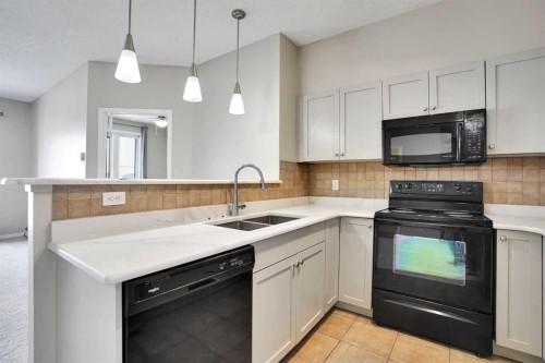 2415-1140 Taradale Drive Ne, Calgary, AB - Indoor Photo Showing Kitchen With Double Sink