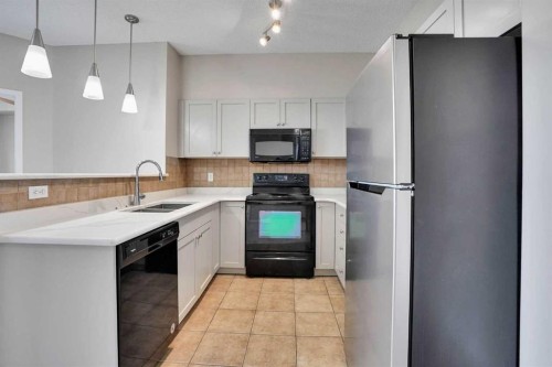 2415-1140 Taradale Drive Ne, Calgary, AB - Indoor Photo Showing Kitchen With Double Sink