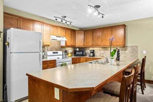 215-150 Crossbow Place, Canmore, AB - Indoor Photo Showing Kitchen With Double Sink
